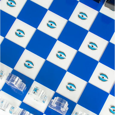 acrylic chess set with an eye design close up view