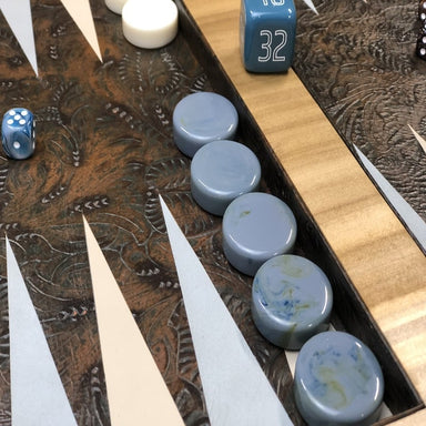 luxury backgammon board in wood and leather with gray and white checkers close up view of the leather