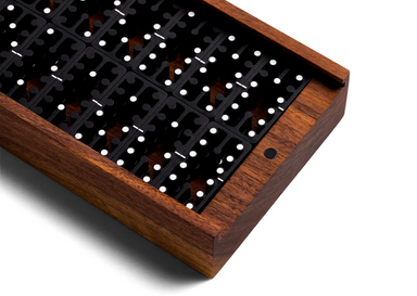 domino set in black aluminum with walnut wooden box close up diagonal view